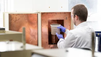 Person in lab coat loading marinelli