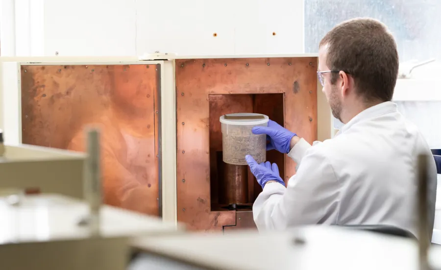 Person in lab coat loading marinelli