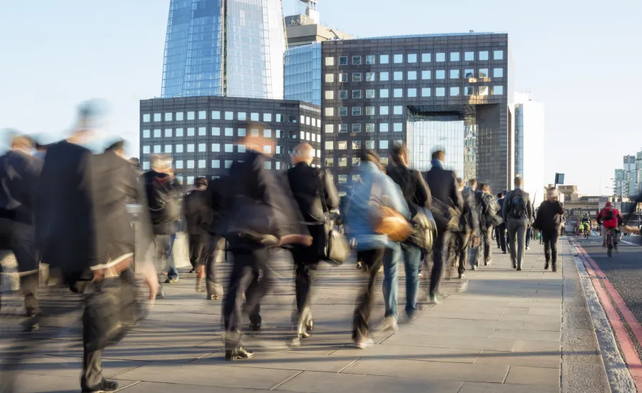 Street of people walking past buildings
