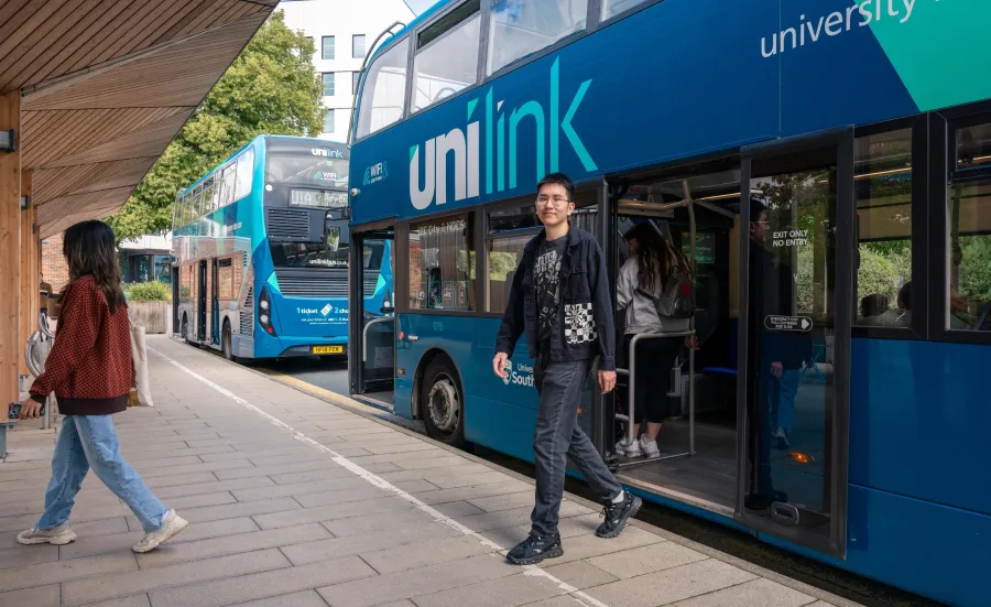 A student alighting a double decker bus at the University of Southampton's Highfield campus.
