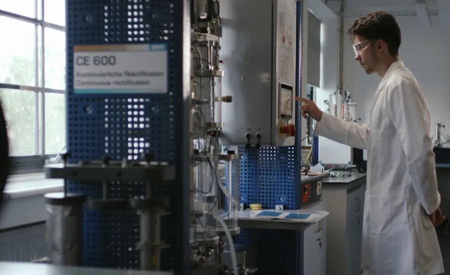 Chemical Engineering student examining equipment