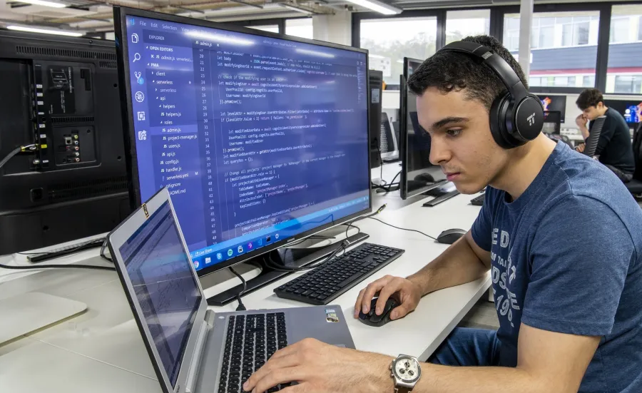 Professor Sumeet Mahajan and student at a computer
