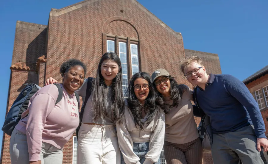 5 students stood in front of the Hartley library