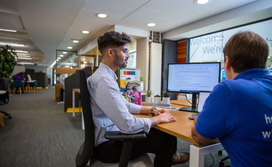 A student meets with a careers adviser for individual guidance in an on-campus careers space.
