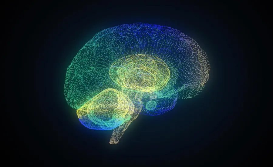 A digital illustration of a human brain made up of small glowing dots in blue, green and yellow on a dark background.