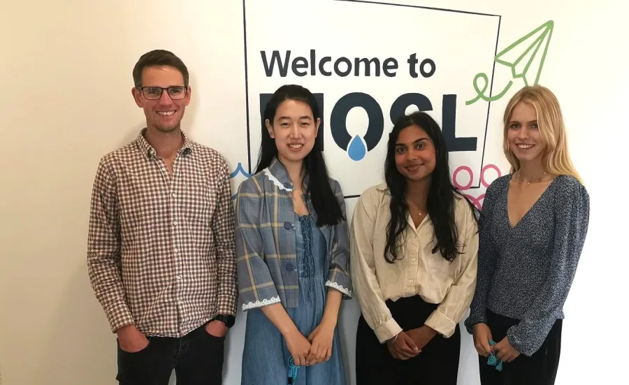 4 students standing in front of a MOSL sign.