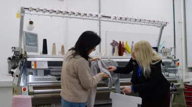Students with textiles machine