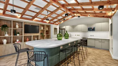The dining room at Capital House. Shows a counter top dining area in a kitchen with an exposed beam ceiling.