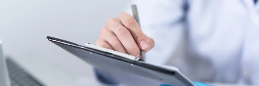 Hand writing on a clip board