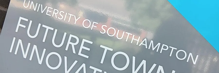 Sign reading "University of Southampton Future Towns Innovation Hub" on a brick wall.