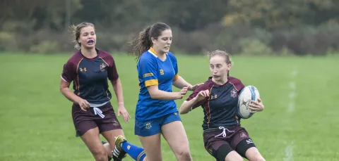 Team Southampton escape a tackle in ladies' rugby match.