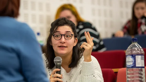 Student talking with microphone during a lecture.
