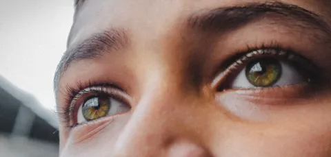 Close up of a young person's eyes looking into the distance