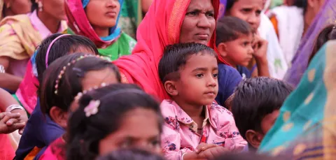 A group of Indian mothers and children in brightly coloured clothing