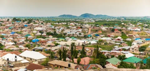 A view of a many large, new houses from a high vantage point on the outskirts of Ado, a settlement that developed due to the expansion of Nigeria's capital of Abuja