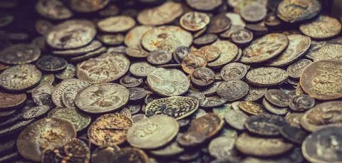 A close-up stock image of various ancient coins.
