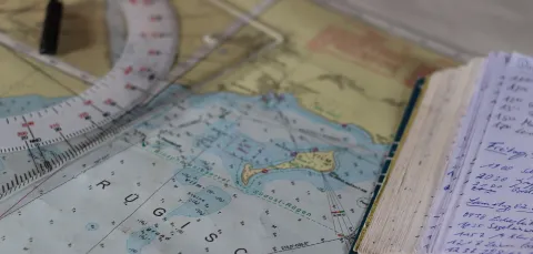 Nautical chart and a notebook on a table