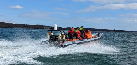 Powerboat moving away from the camera