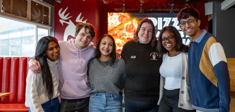Group of smiling students in bar