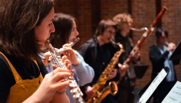 A group of young musicians playing a range of brass and wind instruments