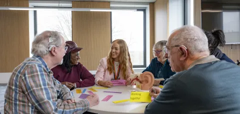 Kate discussing hearing loss and brain health with a group of older people 