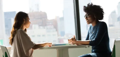 Two women talking at a table