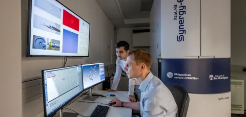 Two chemical technicians reviewing Electron Diffraction data on a computer screen at the NEDF facility