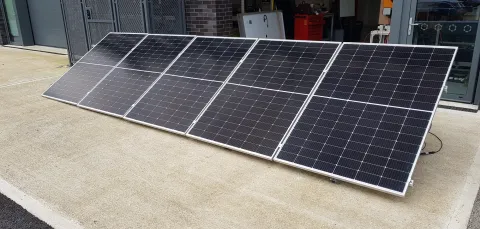 Solar panels on the floor at the entrance of a workshop