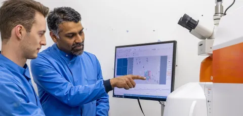 Professor Sumeet Mahajan and student at a computer