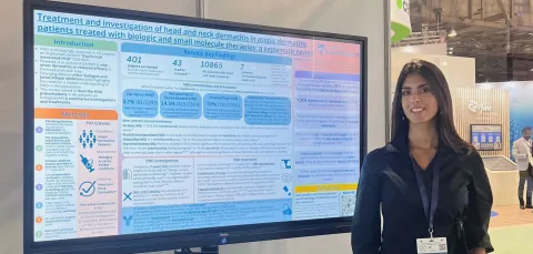 Hannah presenting her research in front of  a whiteboard