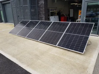 Solar panels on the floor at the entrance of a workshop