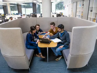 Group of students studying together in cosy study pod.