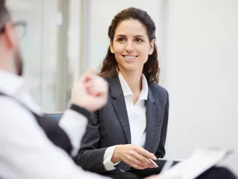 Student in suit talking to academic.