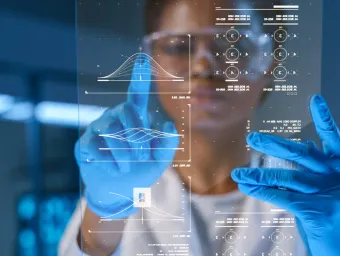 A researcher wearing blue medical gloves scrolls data on a screen