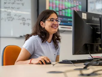 Navya Gulati working at a computer station