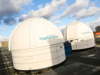 Two domes of the observatories on the roof of the Physics building, a brilliant white in some bright sunshine
