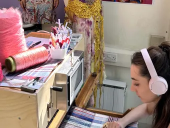 Student sat using textile's equipment and facilities at the Winchester School of Art.