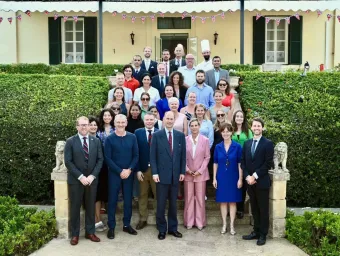 Their Royal Highnesses the Duke and Duchess of Edinburgh, Jacob Brooks and the embassy staff standing on the steps outside the British embassy in Malta.