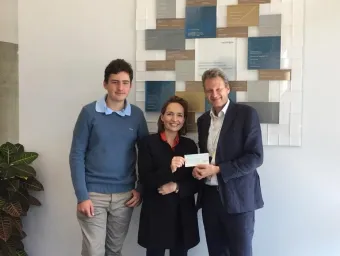 Liza presenting a cheque