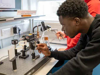 A physics student engaging with lab work