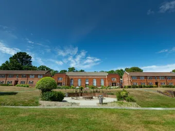 An exterior view of the Glen Eyre halls of residence at the University of Southampton, including a grassy courtyard area.