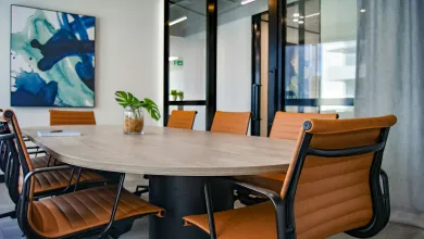 An empty boardroom with brown leather chairs
