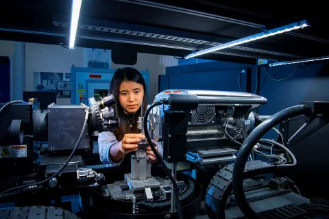 A mechanical engineering student uses a piece of complex machinery