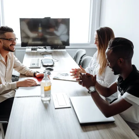 three people in discussion in business meeting room
