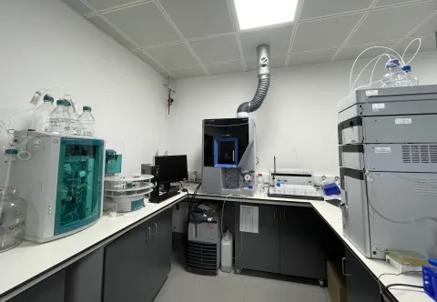 Analytical area at the environmental laboratory with advanced scientific instruments, computer monitor, and exhaust pipe