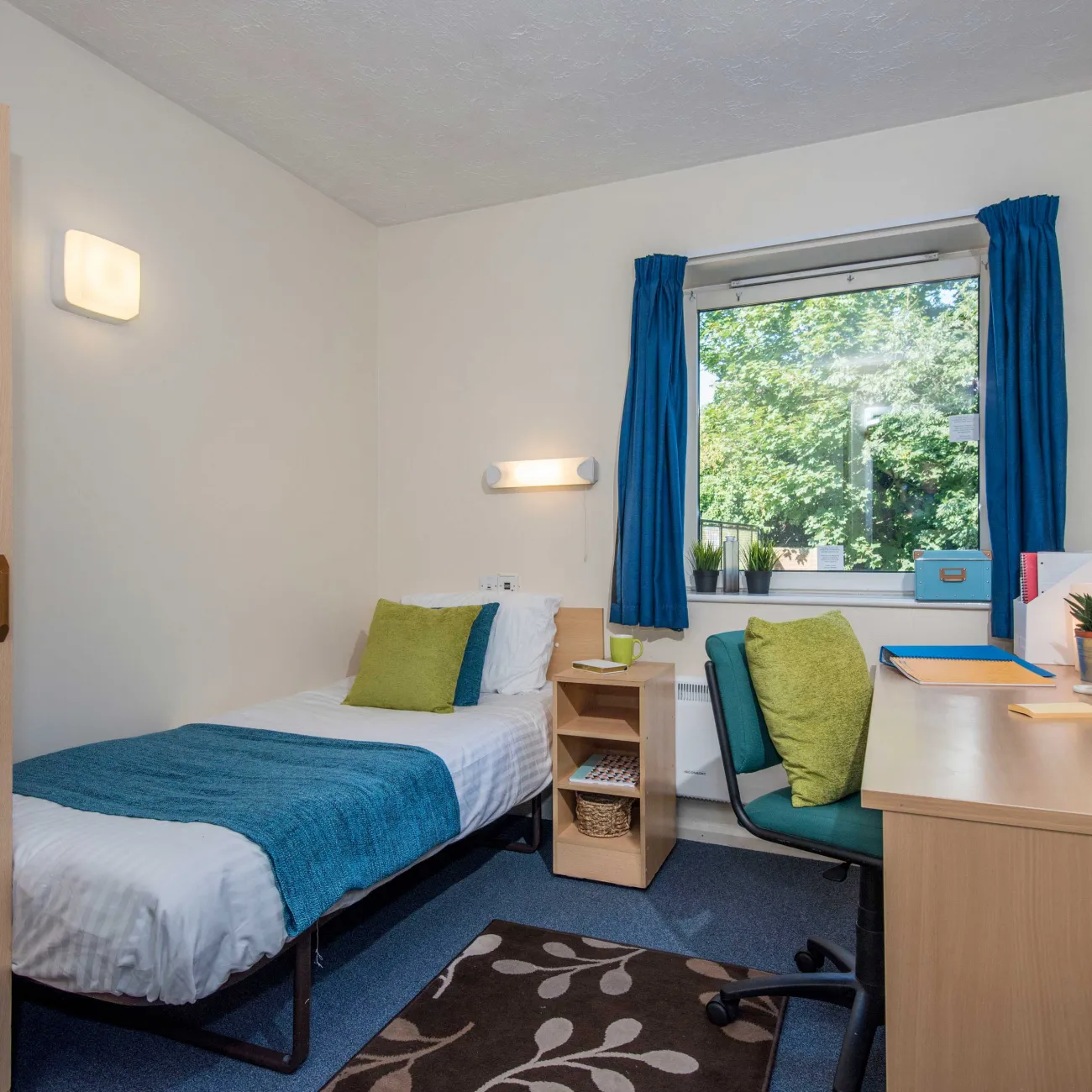 Student bedroom showing bed and desk.