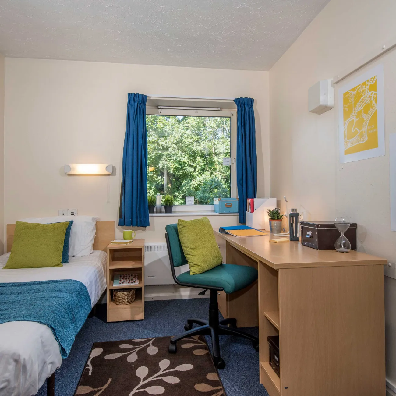 Student bedroom showing bed and desk.