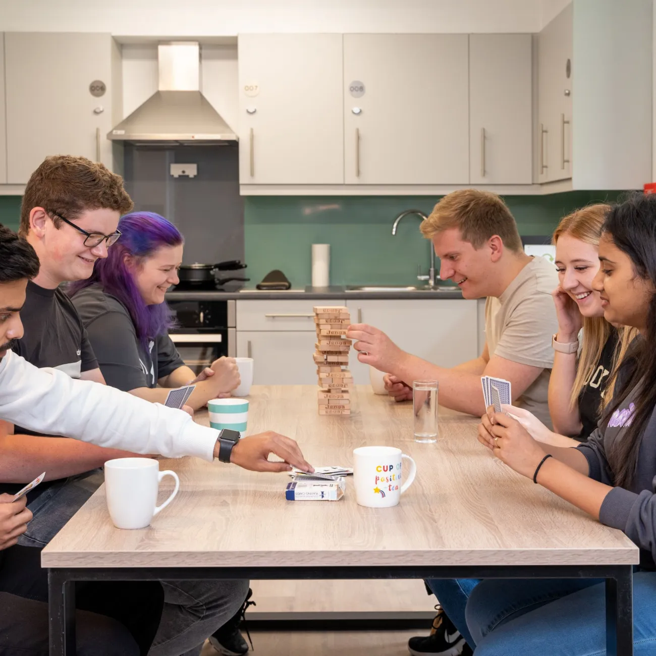 Students in accommodation at a dining table.