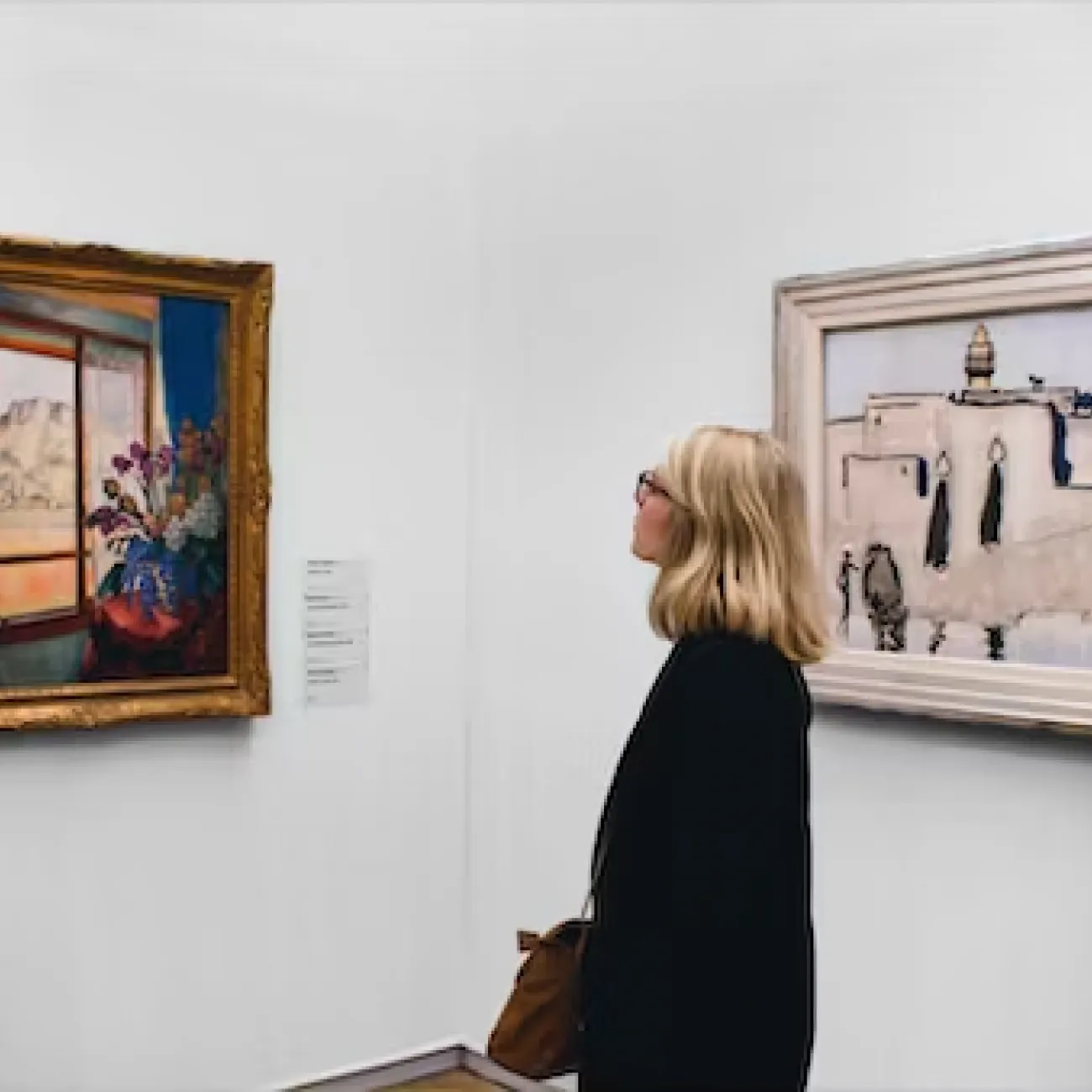 Woman viewing a painting in a museum