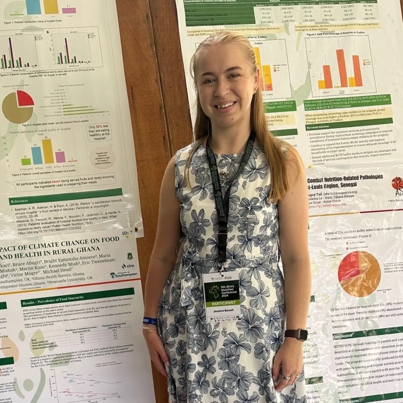 Medicine student standing by poster